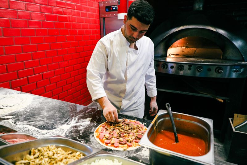 Open kitchen at Pizza luce where handcrafted pizzas are made fresh daily